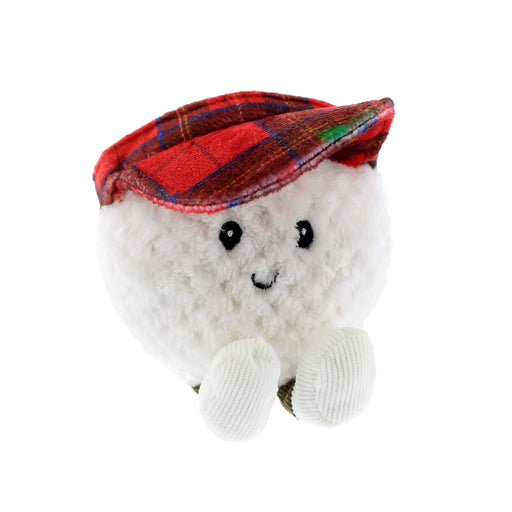 Plush toy resembling a golf ball with a red tartan hat on a white background - Image
