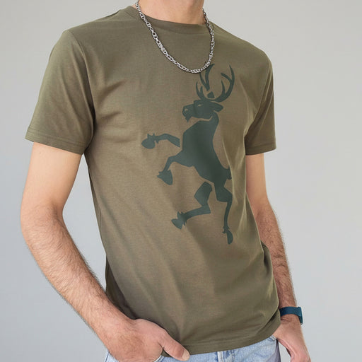 Person wearing a green t-shirt with a deer graphic on a plain background - Image