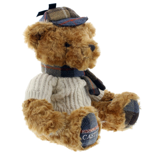 Teddy bear wearing an Arran sweater, tweed scarf, and hat with 'Edinburgh Castle' branding'  on a white background - Image