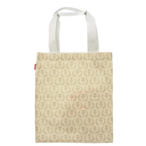 A canvas tote bag with white shoulder straps, featuring an all-over repeating pattern of Scottish Thistles in a muted gold-brown hue on a warm cream background. - Image