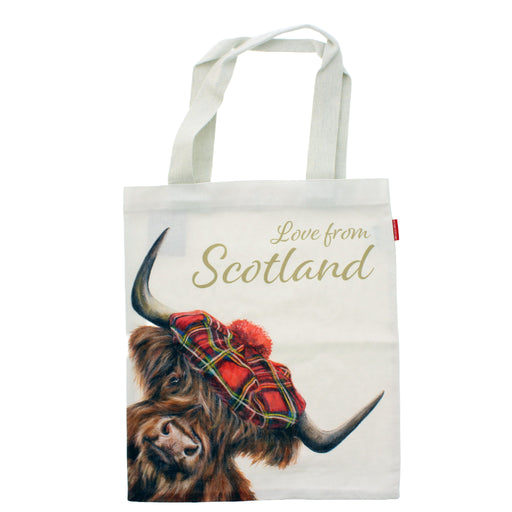 A white canvas tote bag featuring a printed illustration of a Highland cow wearing a red tartan bonnet, with the text 'Love from Scotland' in gold script on the front. - Image