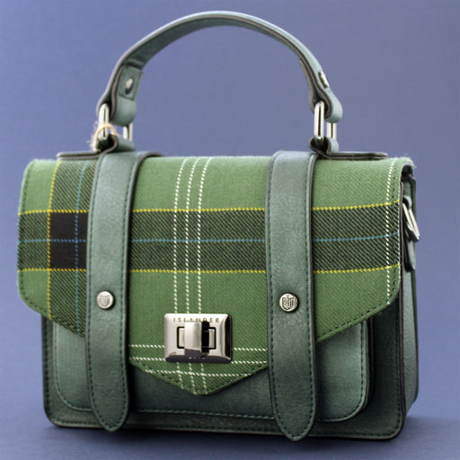 A blue Stirling Castle Tartan flap satchel style bag against a blue background. - Image