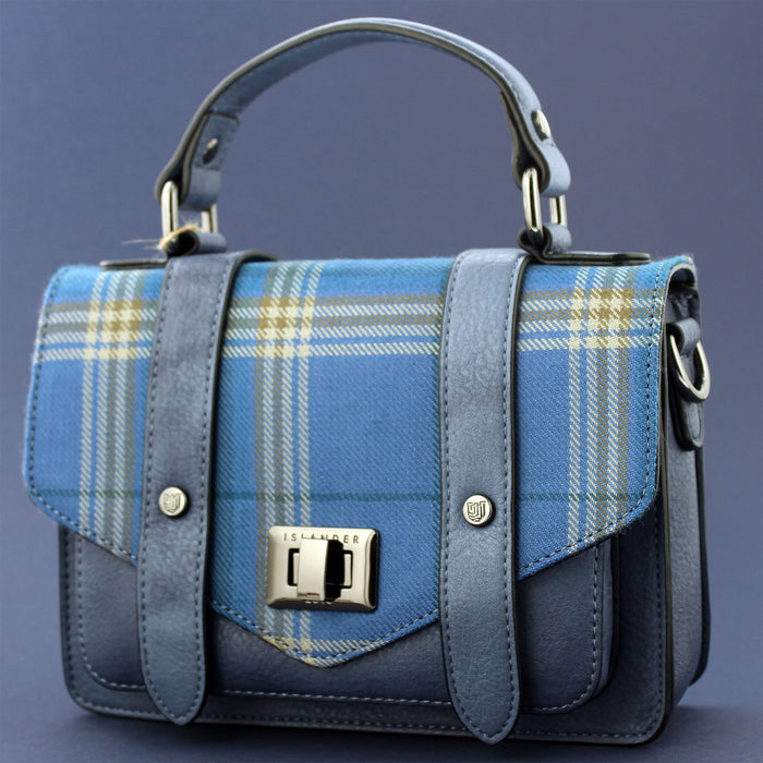 A blue Urquhart Castle Tartan flap satchel style bag against a white background. - Image