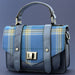 A blue Urquhart Castle Tartan flap satchel style bag against a white background. - Image