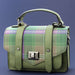 A green Bracken Tartan flap satchel style bag against a blue background. - Image