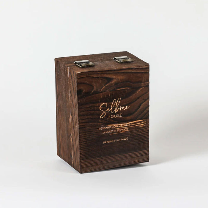 A dark brown wooden keepsake box with a visible wood grain pattern, featuring two metal clasps on top and gold-etched text that reads 'Selbrae House' on a clean white background. - Image