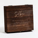 Brown wooden box with signature etched text reading 'Selbrae House', Highland Cow Hip Flask & Cup Set'.  - Image