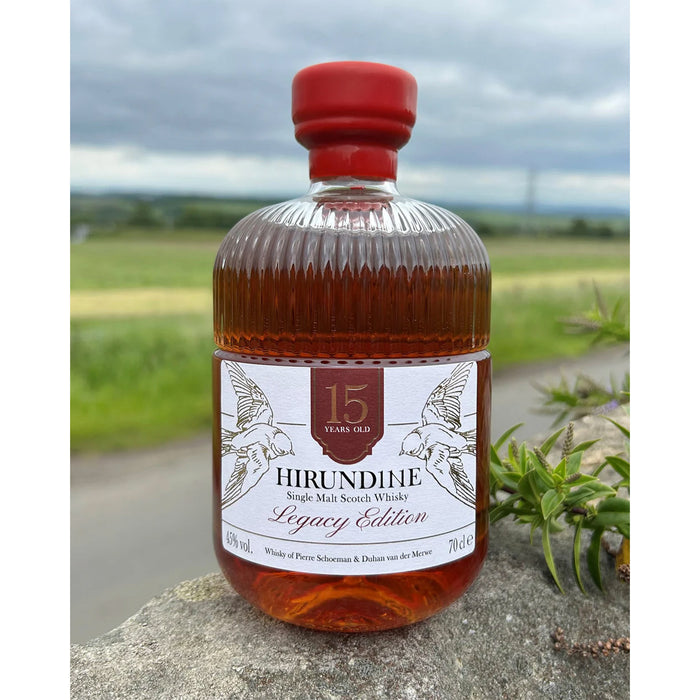 Bottle of Hirundine whisky with a scenic background - Image
