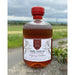 Bottle of Hirundine whisky with a scenic background - Image