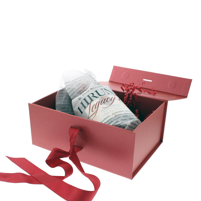 Red gift box with a wrapped bottle of Hirundine Legacy with a red ribbon on a white background - Image
