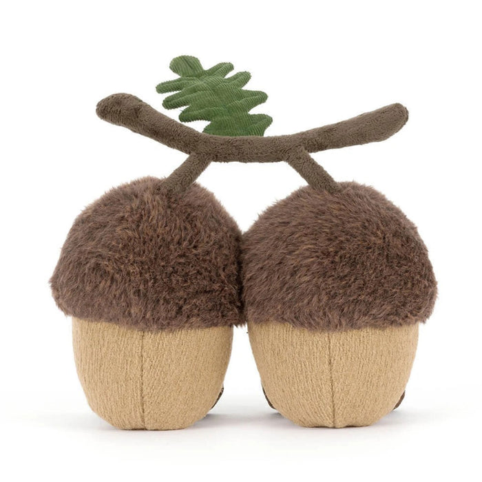 A pair of plush acorn-shaped slippers with fuzzy brown caps, beige textured bodies, brown stems, and a small green leaf on top, shown on a plain white background. - Image