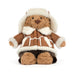 A plush teddy bear dressed in a brown and cream sheepskin-style winter outfit with a matching hat, photographed on a clean white background. - Image