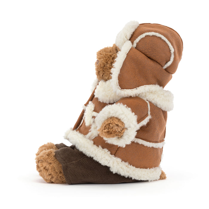 A plush teddy bear in brown faux fur and dark brown corduroy, decorated with white faux fur trim, shown on a white background. - Image