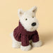 White plush scottie dog soft toy wearing a burgundy aran sweater against a yellow background - Image
