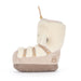 Soft toy snow boot with a soft cream sheepskin-like collar and trim, a light beige suede-like body, and a taupe sole, shown from the side on a white background. - Image
