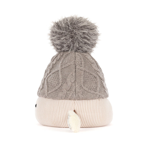 Side view of a soft toy wearing a grey Aran pom pom hat - Image