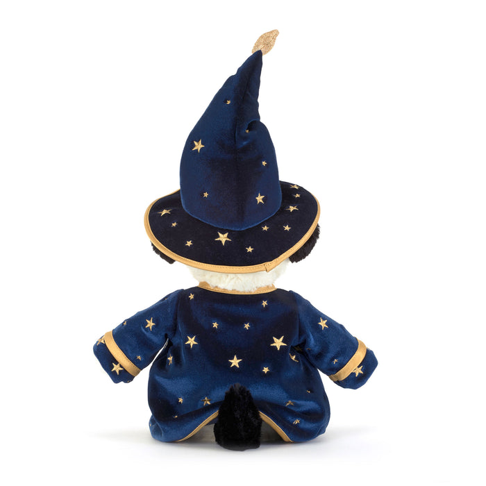 A plush toy  shown from the back, wearing a dark blue wizard costume with gold star details and a matching pointed hat on a white background. - Image