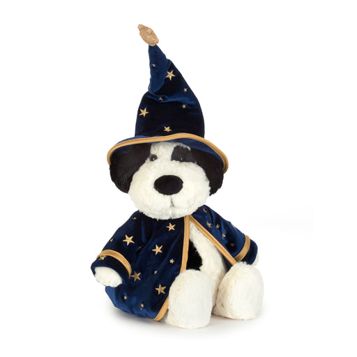 A plush dog toy dressed as a wizard, featuring a navy blue velvet robe and pointed hat with gold star patterns and trim, set against a plain white background. - Image