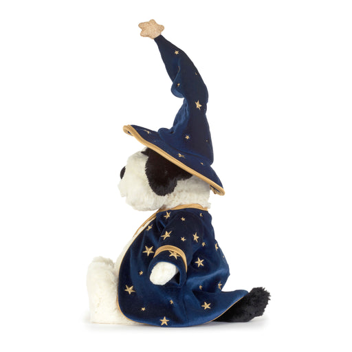 A plush dog toy dressed as a wizard, wearing a tall navy blue pointed hat and matching robe decorated with gold stars and a crescent moon, set against a plain white background. - Image