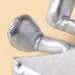 Close-up of the metallic silver textured feet of a plush silver star - Image