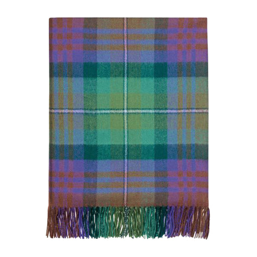 Plaid tartan throw in green and purples folded on a white background.  - Image