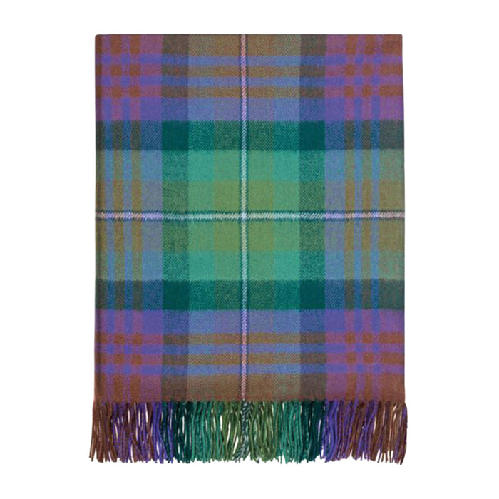 Plaid tartan throw in green and purples folded on a white background.  - Image