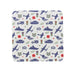A square coaster with rounded corners featuring a military-themed pattern of navy blue tanks, ships, planes, chevrons, medals, red poppies and stars.  - Image
