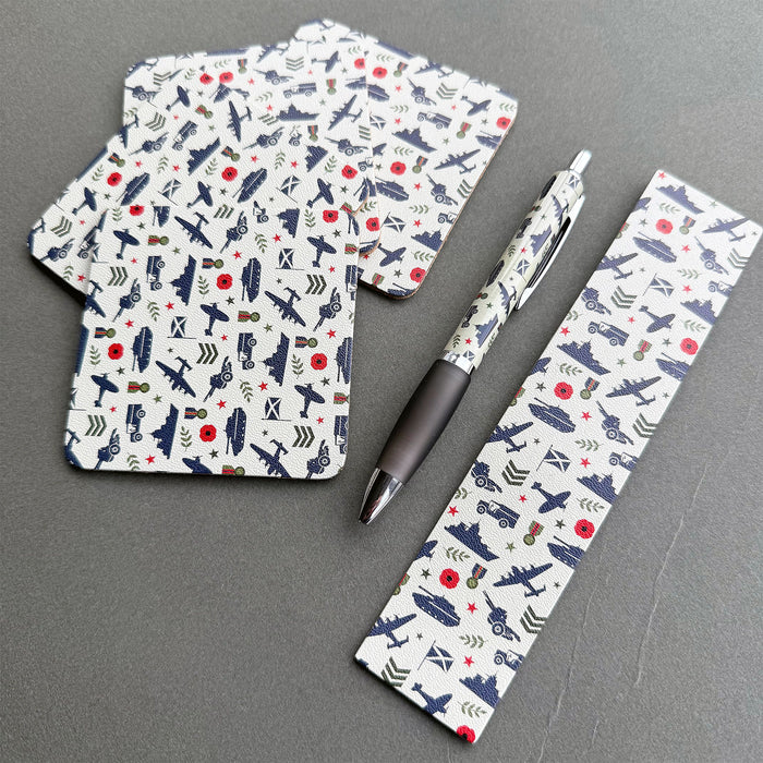 A matching set of accessories featuring  a navy blue and red military-themed pattern of aircraft, helicopters, and vehicles. The set includes a pen, a small coasters, and bookmark. - Image