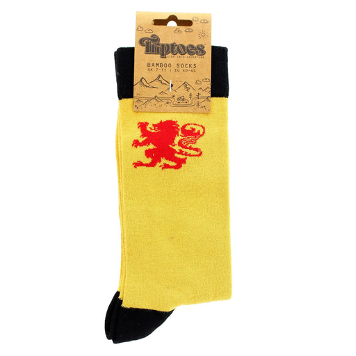 Yellow sock with red lion rampant design and black cuff, displayed with packaging on a white background - Image