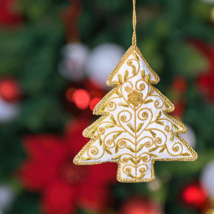 Decorative White star tree decoration with blurred Christmas tree  - Image