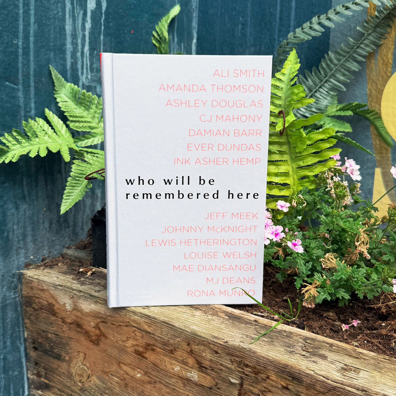 who will be remembered here book on a plant box.  - Image