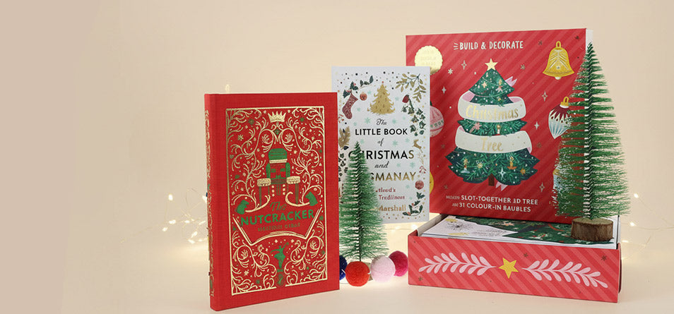 Christmas books with festive ornaments on a neutral background. - Image