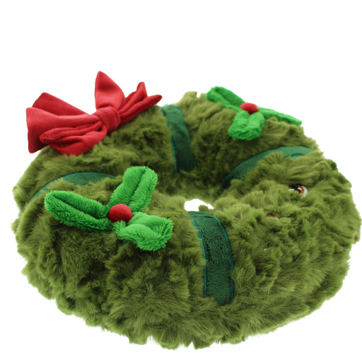 A plush green wreath-shaped soft toy faux fur texture, decorated with a large red bow and green holly leaves with red berries, shown on a plain white background. - Image
