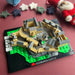 interlocking brick build depicting Edinburgh Castle surrounded by felt decorations against a maroon backdrop - Image