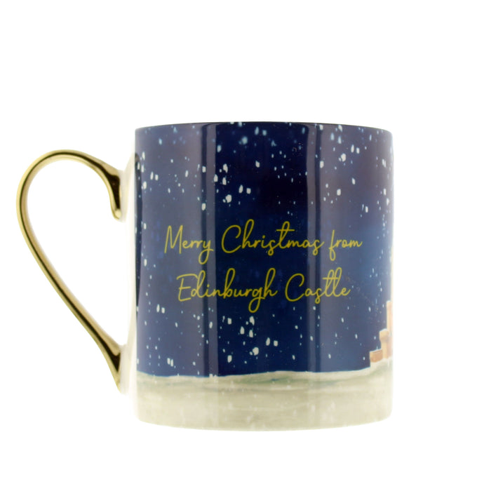A ceramic Christmas mug with a gold handle, featuring a dark blue night sky design with white stars, gold cursive text reading 'Merry Christmas from Edinburgh Castle', and a snowy landscape at the base. - Image