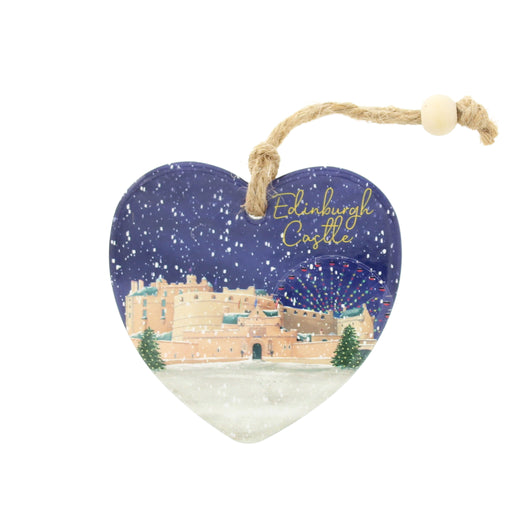 Heart-shaped ceramic Christmas ornament featuring Edinburgh Castle under a snowy night sky, with a natural jute hanging loop and wooden bead. - Image