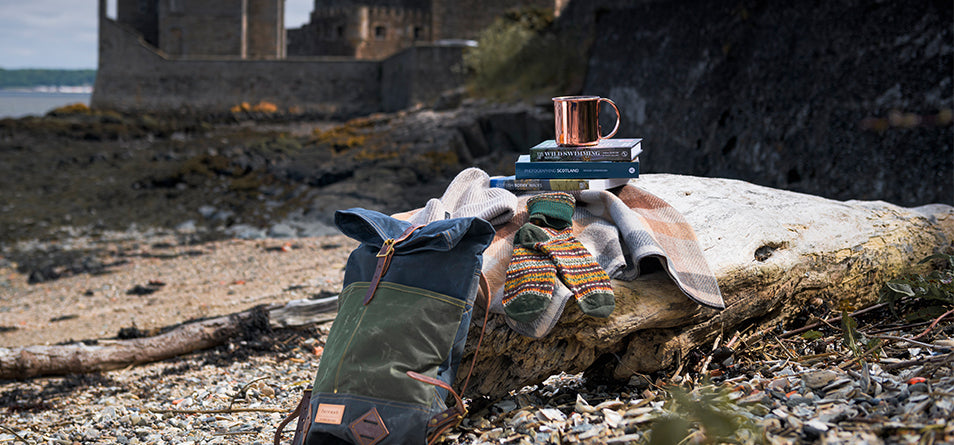 beach with castle in background and selection of accessories