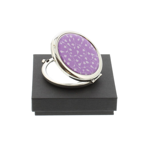 compact pocket mirror with purple tulip repeat pattern shown half open on black gift box