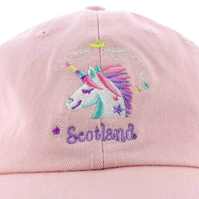 embroidered unicorn logo on pink cap with word scotland in lilac below motif