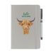 Soft Touch light grey notebook featuring a Highland Cow and the test reads 'hello SCOTLAND'. A light grey strap closes over the right hand side with a stylish pen.