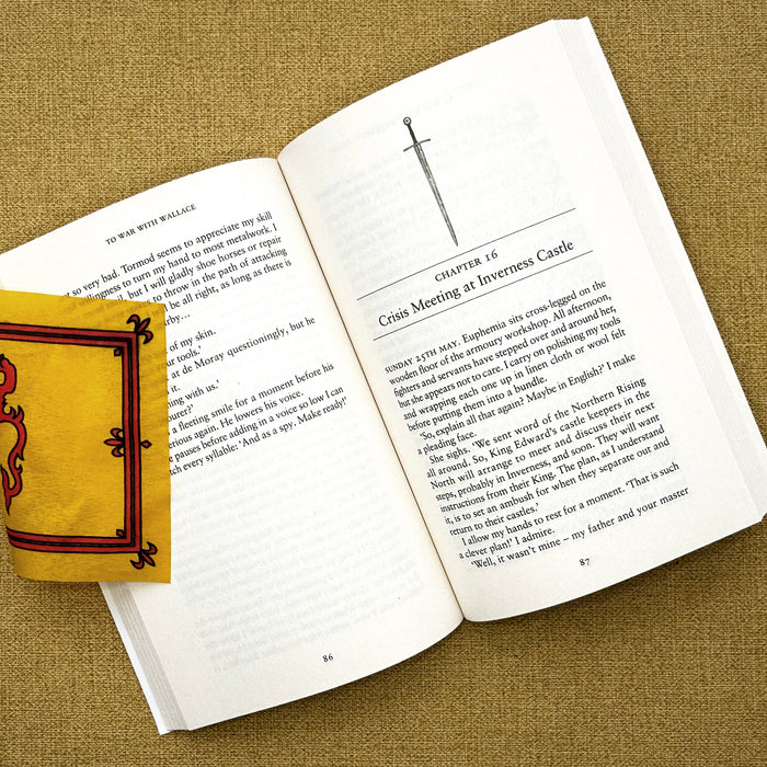 Open book with a yellow bookmark on a textured surface - Image