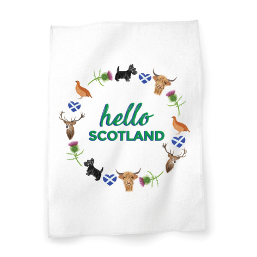 A beautiful designed white cotton tea towel with the words 'Hello Scotland' in green, adorned with illustrations of elements of Scottish culture and scenery.