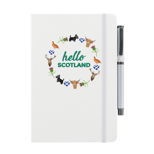 White notepad with pen features a circular prints of Scottish Icons including the St Andrews Flag in a loveheart shape, a pheasant and a deer. A matching strap closes on the right hand side. 