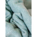 close up of recycled wool herringbone blanket pistachio