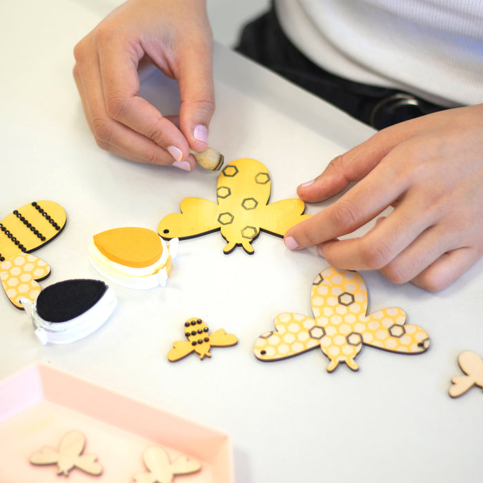 bee mini craft kit showing person adding pattern to the bee cutout