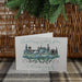Edinburgh Castle Christmas Cards shown next to pine branch and hamper