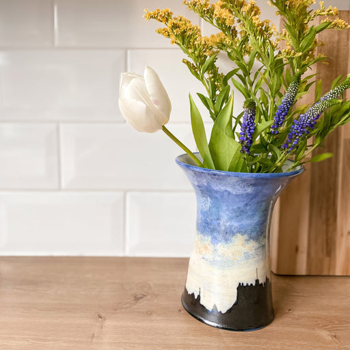 vase with flowers sitting on kitchen countertop