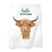 White cotton tea towel featuring a motif of a Highland Cow and the text reads 'hello Scotland'. 