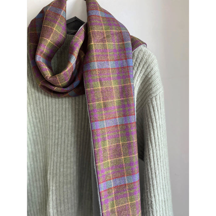 Grassmarket Tartan scarf draped over a jumper