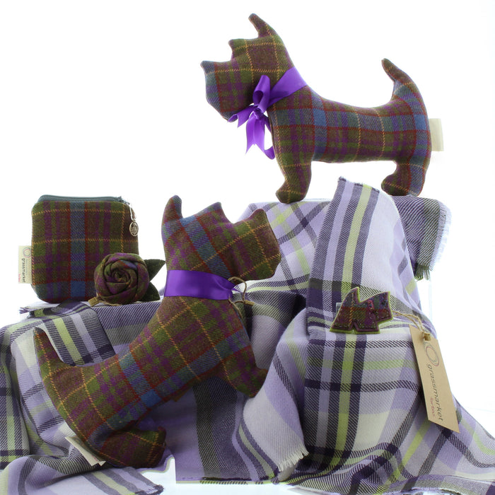 group picture of greyfriars tartan items including small scottie dog cushions, purse, rose brooch and dog brooch